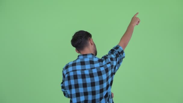 Widok z tyłu młodego Brodaty Perski Hipster mężczyzna wskazując palec — Wideo stockowe