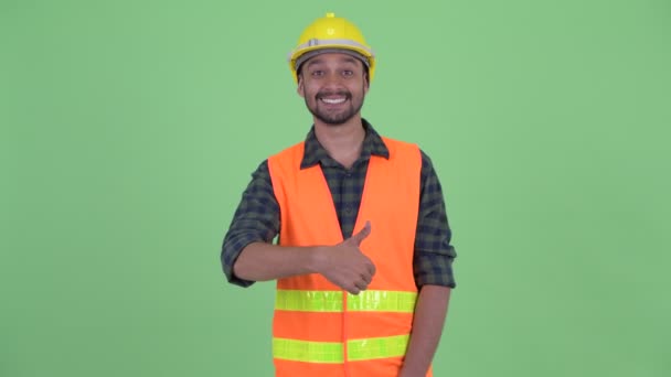 Happy young bearded Persian man construction worker giving thumbs up — Stock Video