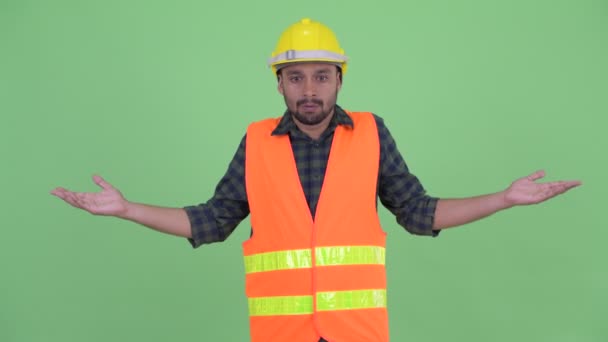 Zdezorientowany młody Brodaty Perski mężczyzna robotnik budowlany wzruszając ramiona — Wideo stockowe