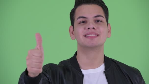 Лицо счастливого молодого красивого многоэтничного мужчины, показывающего большие пальцы — стоковое видео