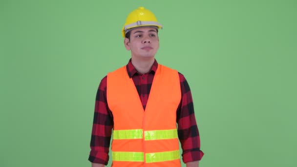 Serious young multi ethnic man construction worker thinking — Stock Video