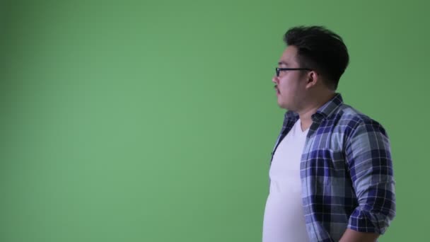 Perfil vista de feliz jovem sobrepeso asiático hipster homem sorrindo — Vídeo de Stock