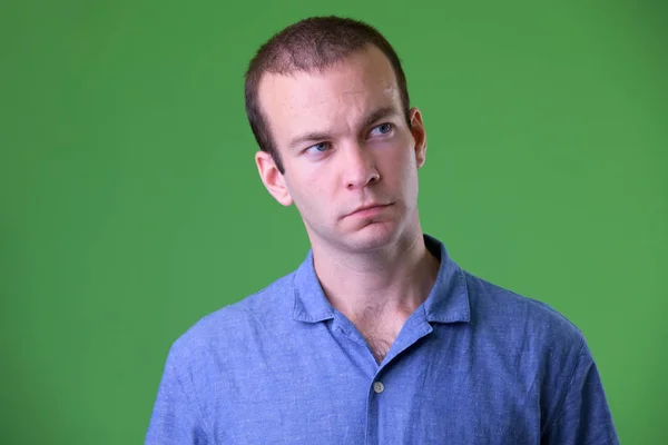 Rostro del hombre de negocios pensando en el fondo verde —  Fotos de Stock