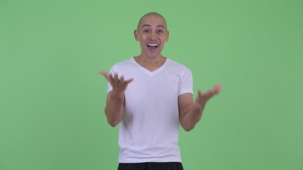 Happy handsome bald man looking surprised — Stock Video