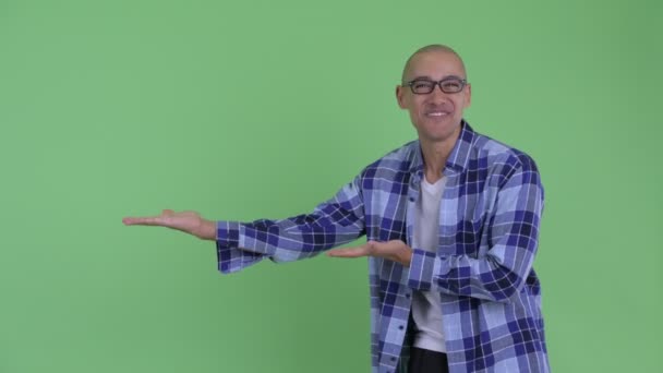 Happy bald hipster man showing something and looking surprised — Stock Video