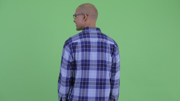 Rear view of happy bald hipster man looking around — Stock Video