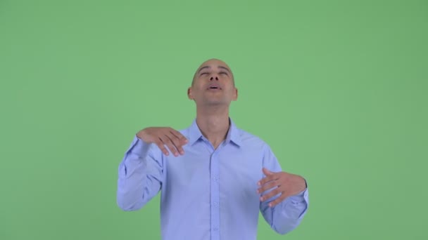 Happy bald multi ethnic businessman catching something — Stock Video