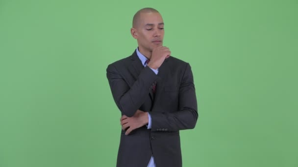 Stressed bald multi ethnic businessman thinking and looking down — Stock Video