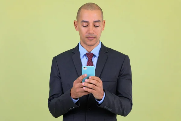 Handsome bald multi ethnic businessman using phone — Stock Photo, Image