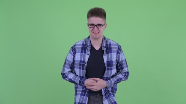 Stressed young hipster man having stomachache — Stock Video