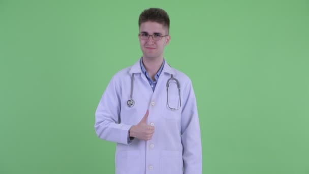 Happy young man doctor giving thumbs up — Stock Video