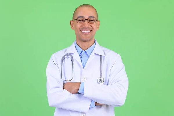 Happy bald multi ethnic man doctor smiling with arms crossed — Stock Photo, Image