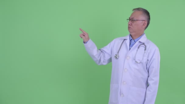 Estresado maduro japonés hombre médico tocar algo — Vídeos de Stock