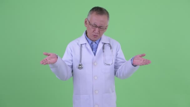 Triste madura japonesa hombre médico encogiendo de hombros — Vídeos de Stock