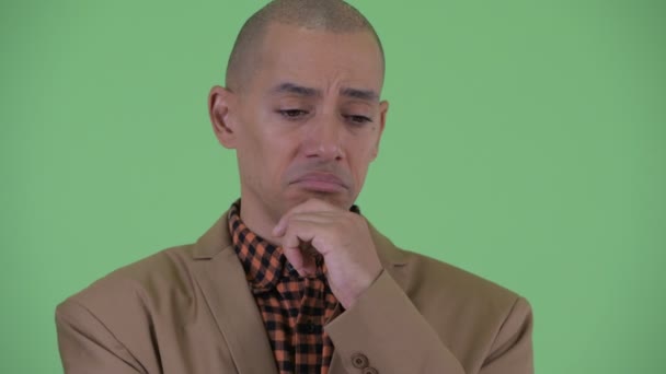 Sad bald multi ethnic businessman thinking — Stock Video