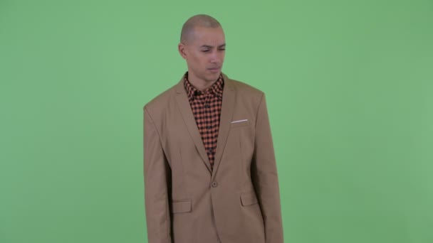 Stressed bald multi ethnic businessman looking around and feeling upset — Stock Video