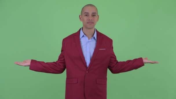 Feliz hombre de negocios calvo multiétnico comparando algo — Vídeo de stock