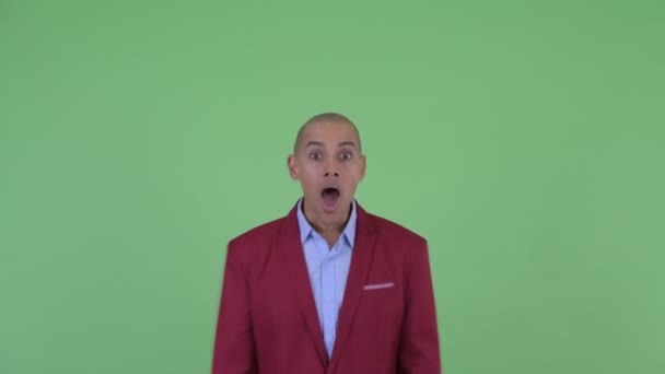 Face of happy bald multi ethnic businessman looking surprised — Stock Video