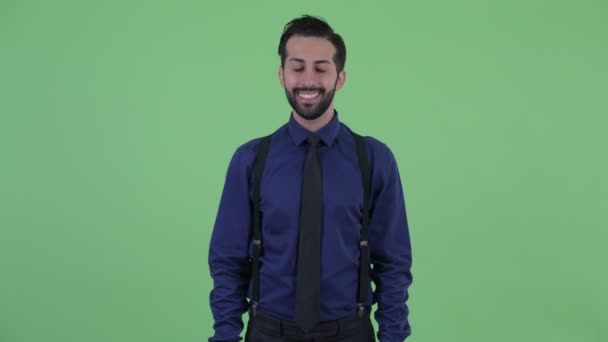 Gelukkige jonge bebaarde Perzische zakenman glimlachend — Stockvideo