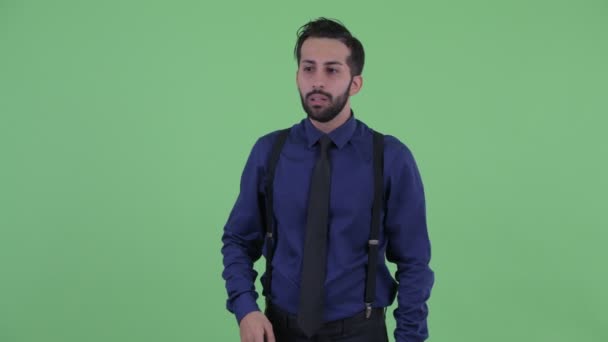 Stressed young bearded Persian businessman looking around and feeling upset — Stock Video