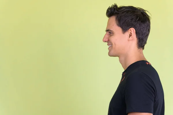 Closeup profile view of happy young handsome man smiling — Stock Photo, Image