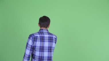Bir şeye dokunan genç hipster adamın arka görünümü