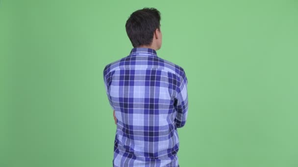 Rear view of young hipster man thinking and waiting — Stock Video