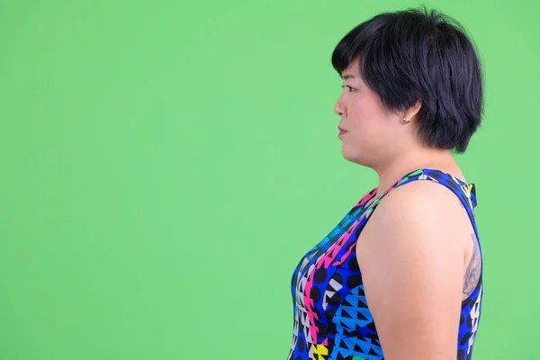 Closeup profile view of young beautiful overweight Asian woman ready to party — Stock Photo, Image