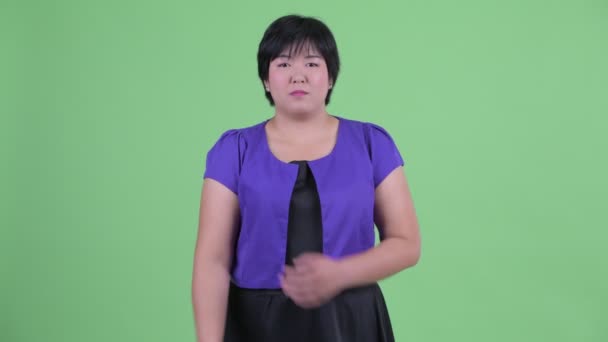 Happy young beautiful overweight Asian woman smiling with arms crossed — Stock Video