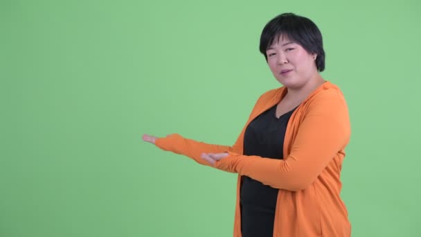 Feliz joven mujer asiática con sobrepeso presentándose a la espalda listo para el gimnasio — Vídeos de Stock