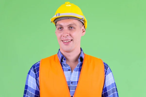 Face of happy young man construction worker thinking — Stock Photo, Image