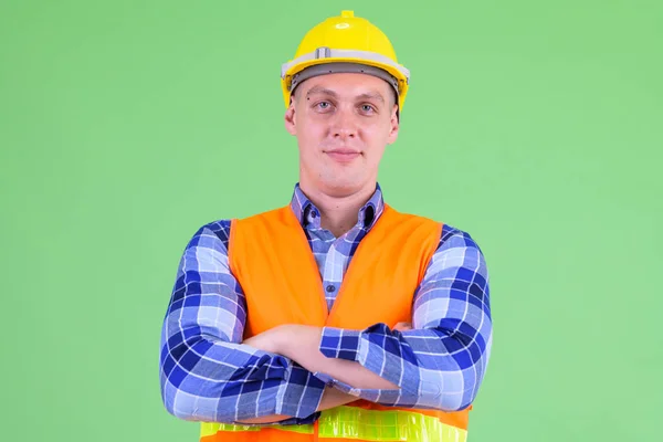 Young man construction worker with arms crossed — Stock Photo, Image