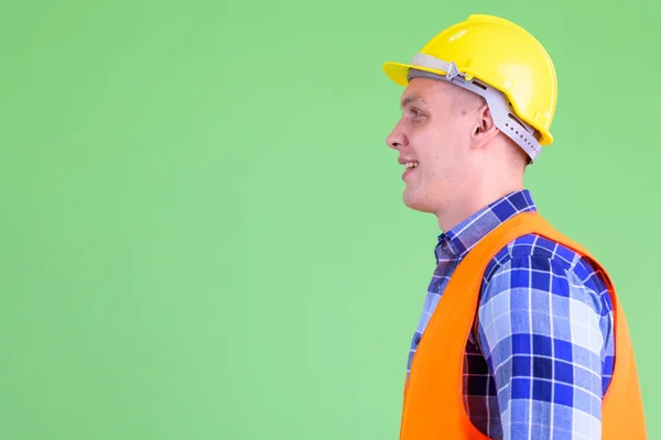 Closeup profile view of happy young man construction worker smiling — Stock Photo, Image