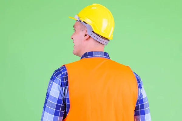 Closeup rear view of happy young man construction worker smiling — Stock Photo, Image