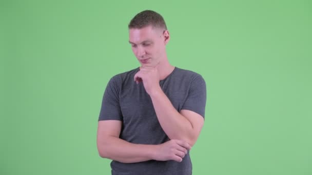 Portrait of stressed young man thinking and looking down — Stock Video