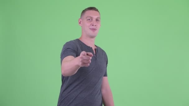 Portrait of happy young man pointing at camera — Stock Video