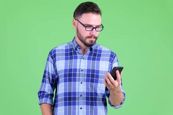 Young handsome bearded hipster man using phone — Stock Photo, Image