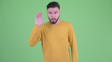 Mutlu genç yakışıklı sakallı adam dinleme ve gülüyor