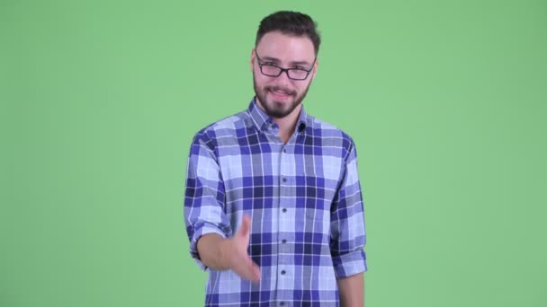 Happy young bearded hipster man giving handshake — Stock Video