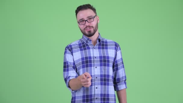 Happy young bearded hipster man pointing at camera — Stock Video