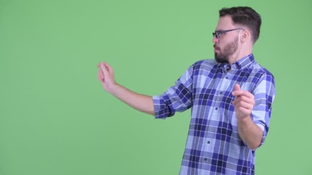 Boldog fiatal szakállas csípő ember megható valami és harapós ujjak — Stock videók