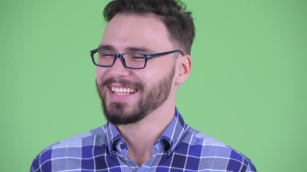 Face of funny young bearded hipster man fake laughing — Stock Video