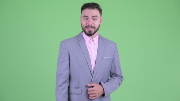 Happy young handsome bearded businessman giving handshake — Stock Video