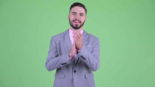 Щасливий молодий бородатий бізнесмен плескає руками — стокове відео