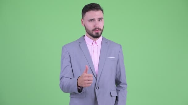 Happy young bearded businessman giving thumbs up and looking excited — Stock Video