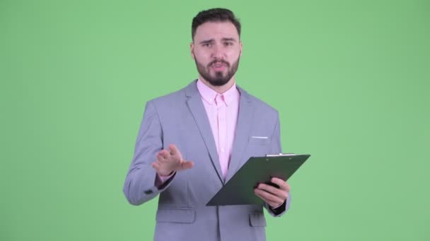 クリップボードでインタビュー幸せな若いひげのビジネスマン — ストック動画