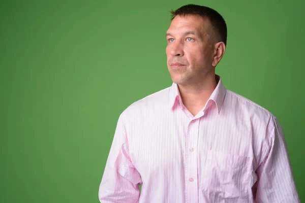 Face of mature macho businessman thinking and looking up — Stock Photo, Image