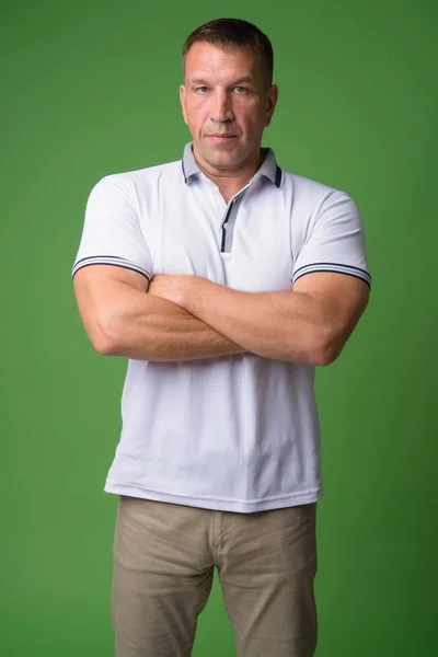 Portrait of macho mature man with arms crossed — Stock Photo, Image