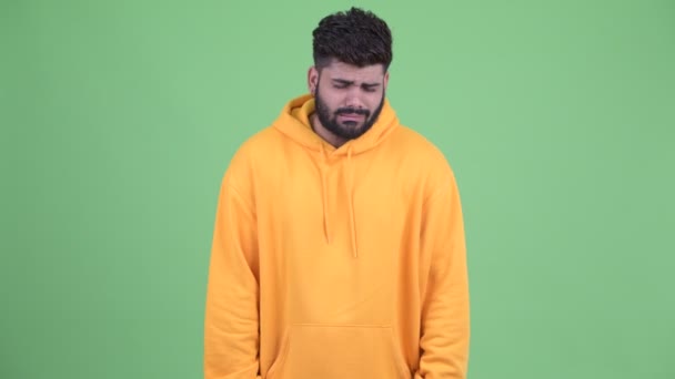 Stressed young overweight bearded Indian man looking sad and crying — Stock Video