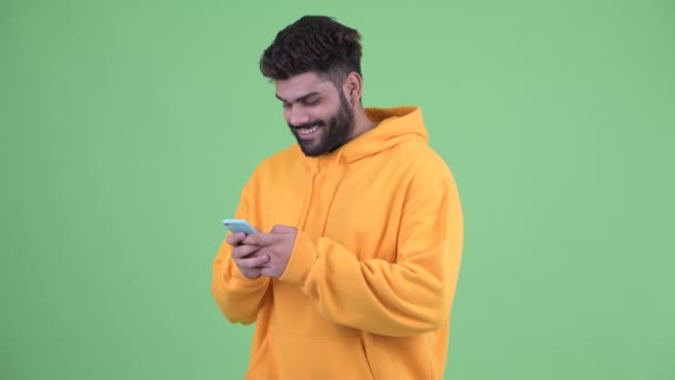 Szczęśliwy młody nadwaga Brodaty Indyjski człowiek za pomocą telefon — Wideo stockowe